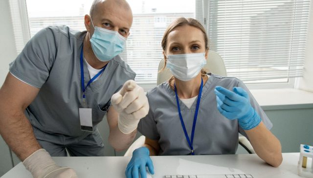 Two dental professionals discussing patient outreach and visibility strategies powered by a local SEO agency.